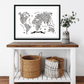 World map poster on a wall above a wooden table with decorative items.