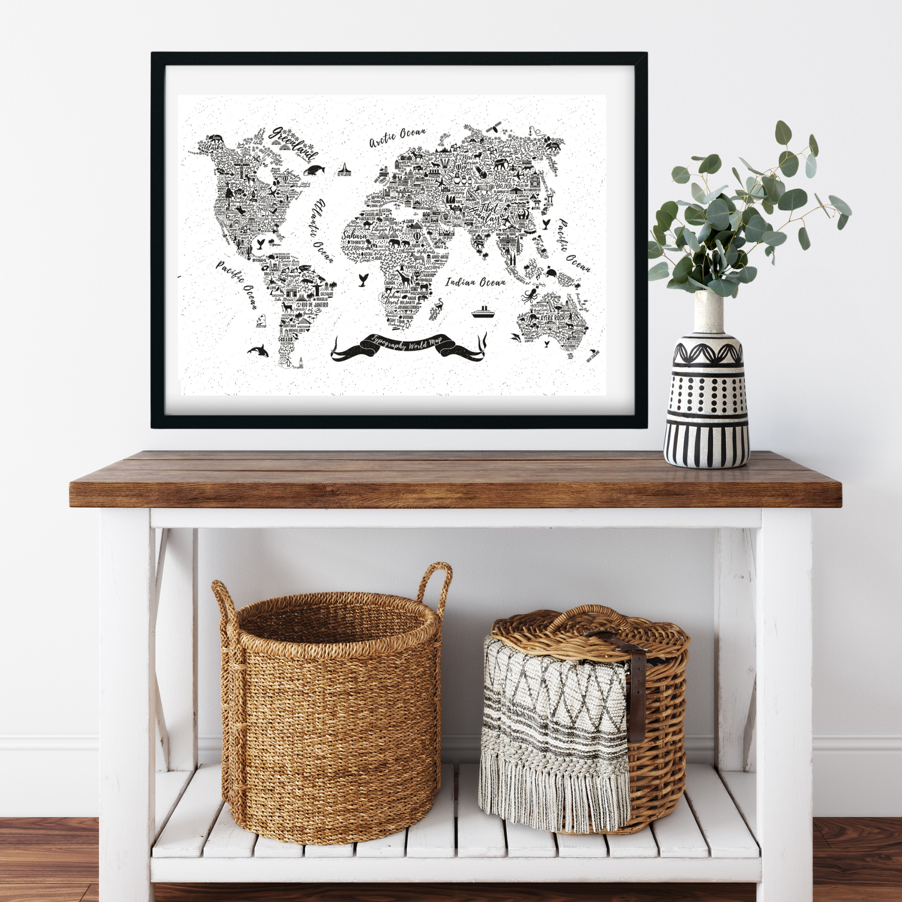 World map poster on a wall above a wooden table with decorative items.