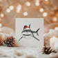Hand-drawn shark wearing a Santa hat, festive Christmas card design.
