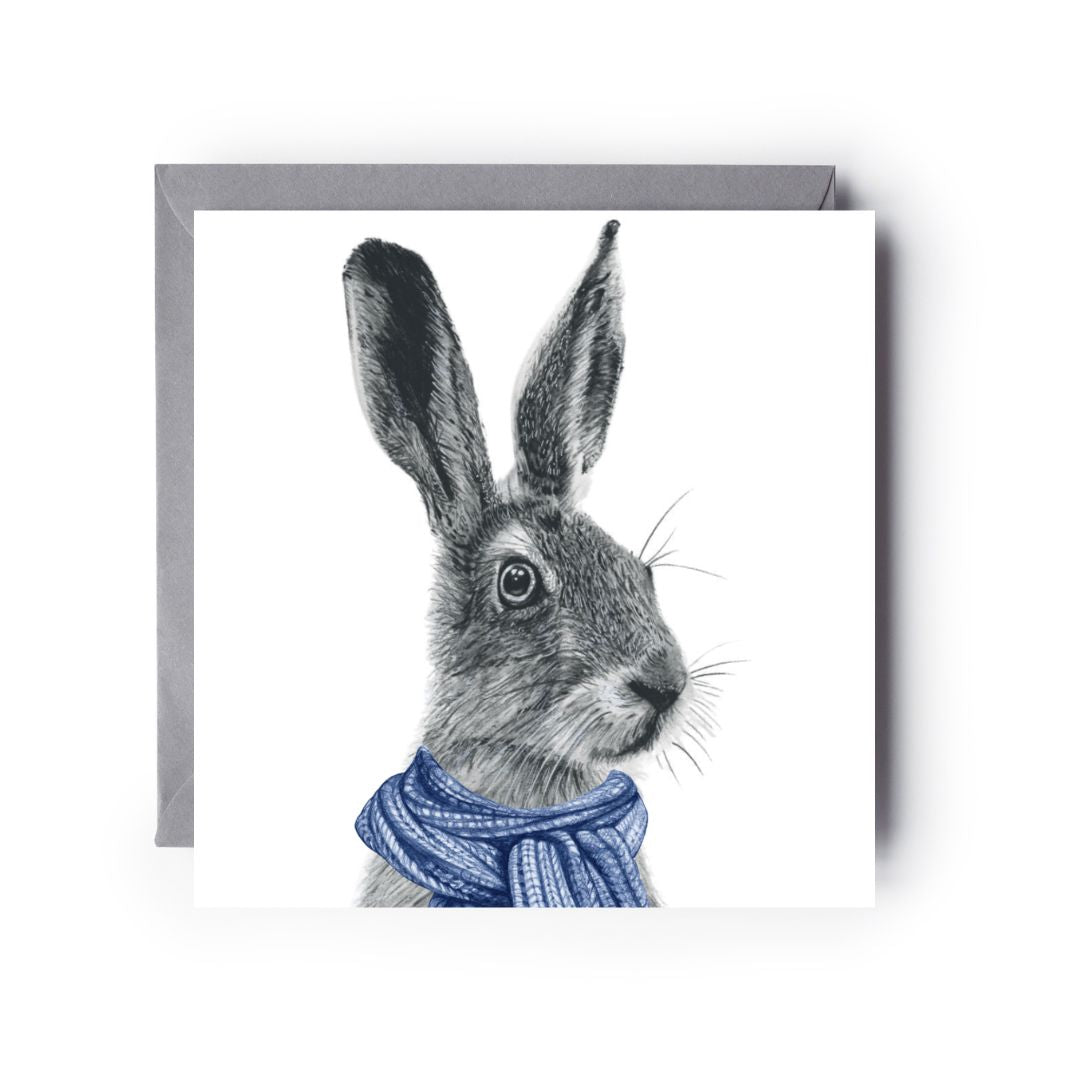 Hand-drawn winter greeting card with a graceful hare wearing a blue scarf.

