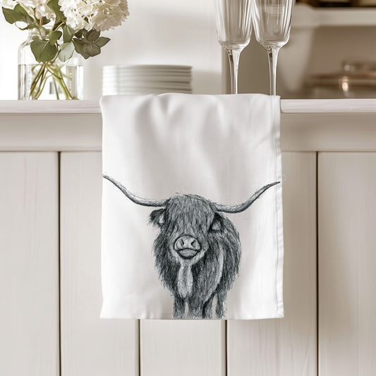 Charming Highland Cow hand-drawn design on a soft cotton tea towel, perfect for animal lovers.