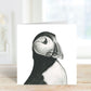 A hand-drawn puffin greeting card from Libra Fine Arts, standing upright to showcase the intricate and charming illustration of the puffin. The card captures the bird's personality with delicate lines and shading, offering a unique and artistic design.