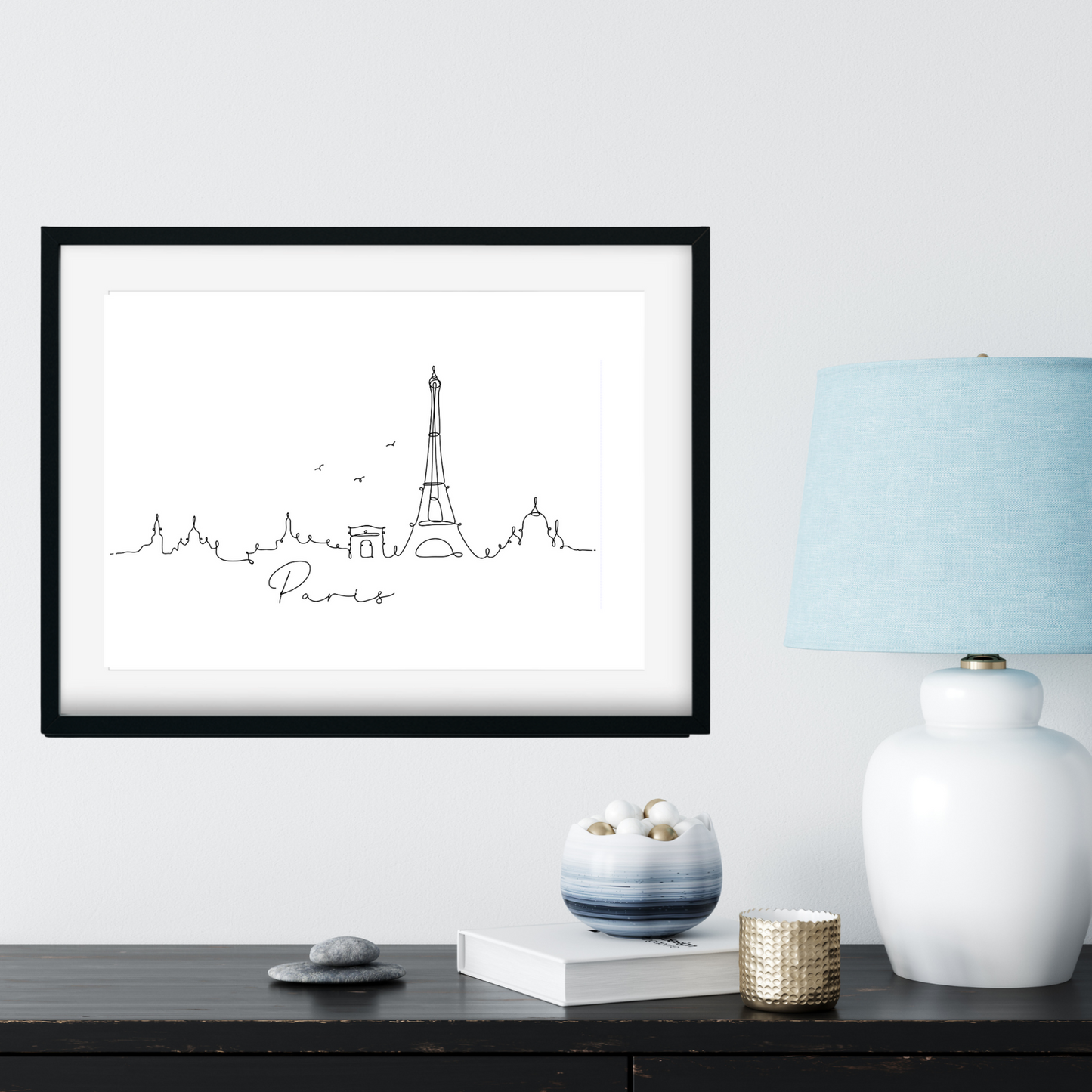 paris skyline print next to blue lamp