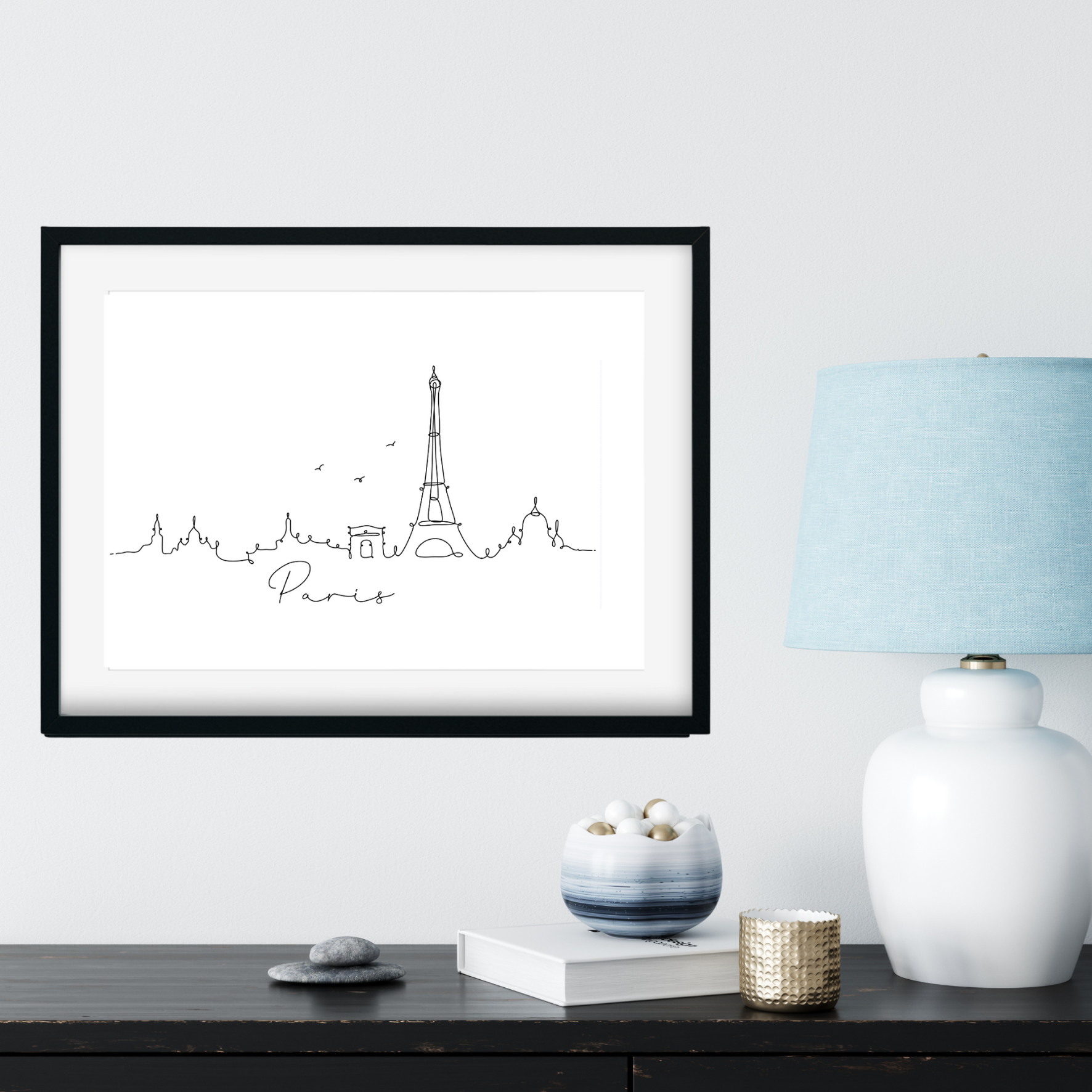 paris skyline print next to blue lamp