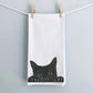 A hand-drawn peeking cat tea towel, made from premium cotton, hanging in a cozy kitchen. Its charming design adds a playful touch to any home, making it an ideal gift for cat lovers and a delightful addition to your kitchen decor.







