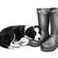 Monochrome artwork of a sleeping Border Collie puppy resting beside wellington boots