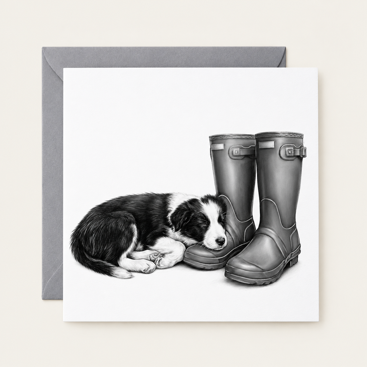Sleeping Puppy & Wellies greeting card with a grey envelope behind it