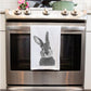 Bunny Premium Tea Towel From Libra Fine Arts . Bunny Premium Cotton Tea Towel: A delightful tea towel made from premium cotton, featuring a hand-drawn bunny design. Ideal for birthday gifts and Christmas presents, this high-quality towel adds a touch of whimsy to any kitchen while making a thoughtful and charming gift for bunny lovers