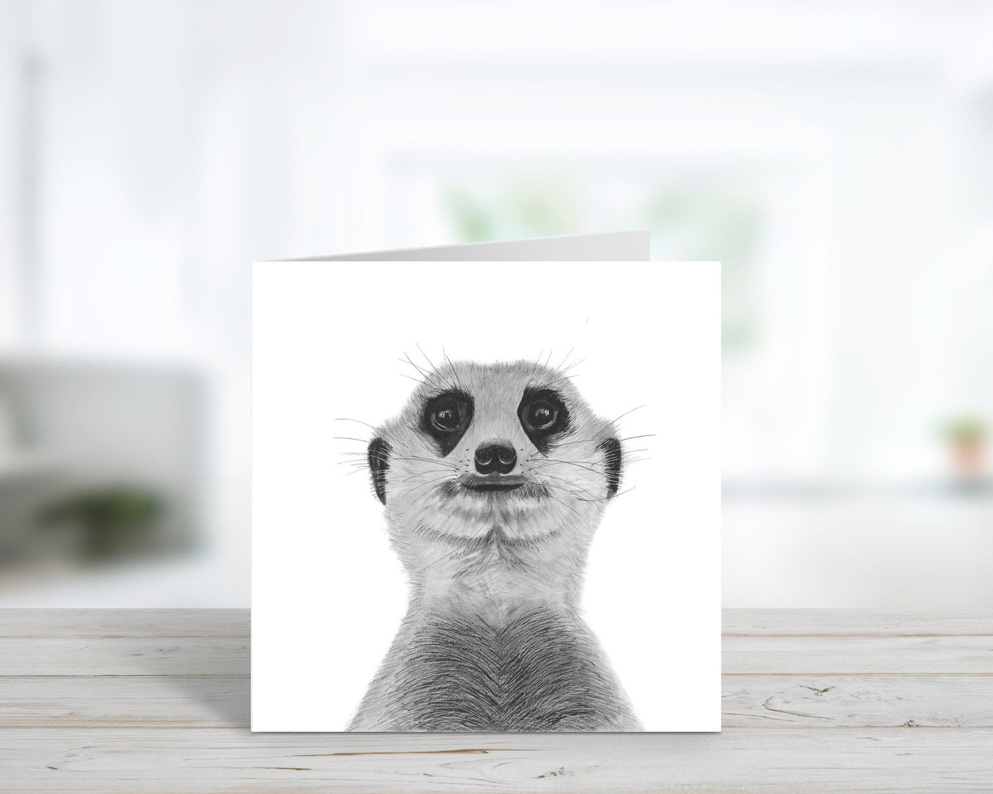 A hand-drawn Myra the Meerkat wildlife greeting card, standing open and ready for a heartfelt message. Perfect for wildlife enthusiasts, animal lovers, and those who appreciate unique artwork. Printed on Libra Fine Arts FSC-certified cardstock, offering a high-quality, eco-conscious choice. Blank inside for a personalized touch.